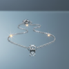 Stainless steel solitaire necklace on blue grey gloss background with mirror reflection