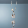 Stainless steel teardrop pendant necklace with zirconia on blue grey gloss background with mirror reflection