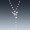 Stainless steel purple butterfly necklace on blue grey gloss background with mirror reflection