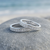 Silver-tone stone-set rings on a coastal rock