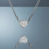 Stainless steel magnetic heart pendant necklace with pave zirconia on blue grey gloss background with mirror reflection