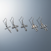 Stainless Steel Faith-Inspired Dangle Earrings on gloss mirror surface