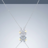 Stainless steel reversible 4-leaf clover pendant necklace with zirconia on blue grey gloss background with mirror reflection