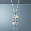 Stainless steel spinning flower pendant necklace with zirconia on blue grey gloss background with mirror reflection